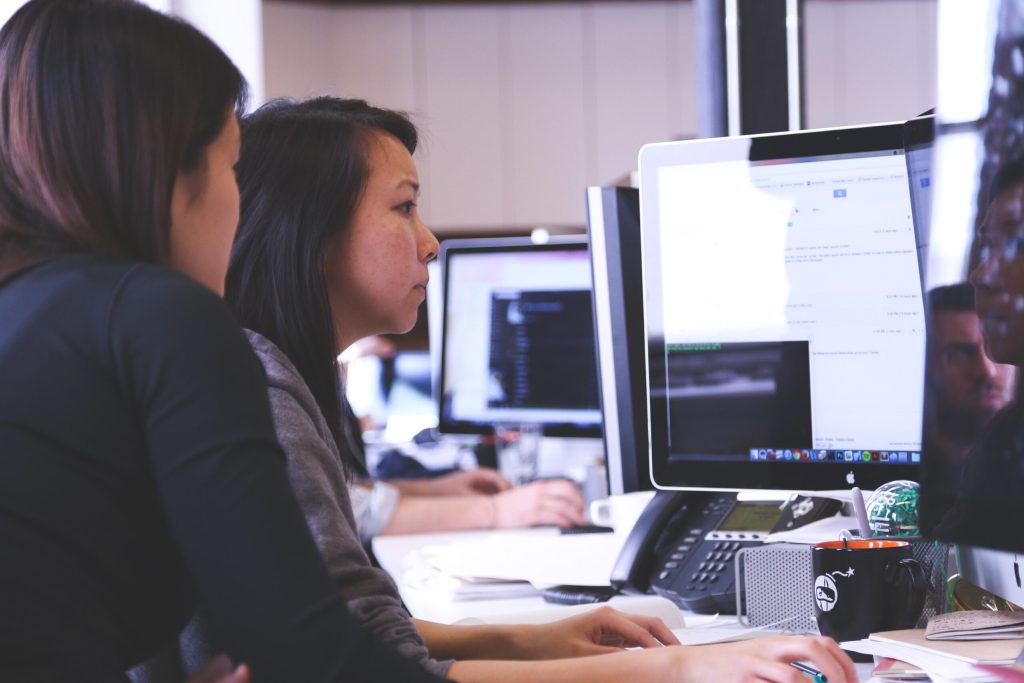 business women looking at computer screen